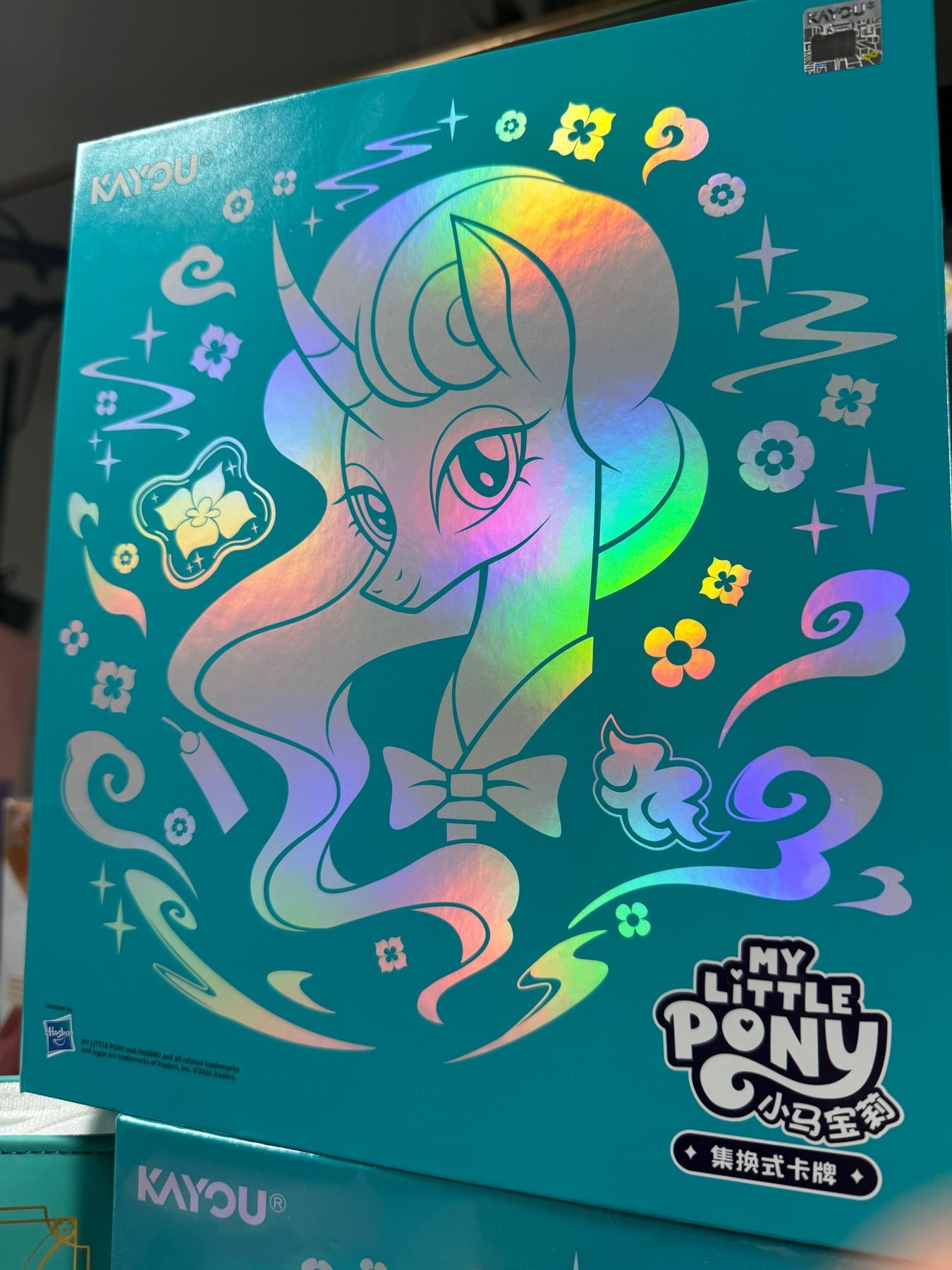 Mistmane's rainbow foil portrait on the front of the KAYOU gift box