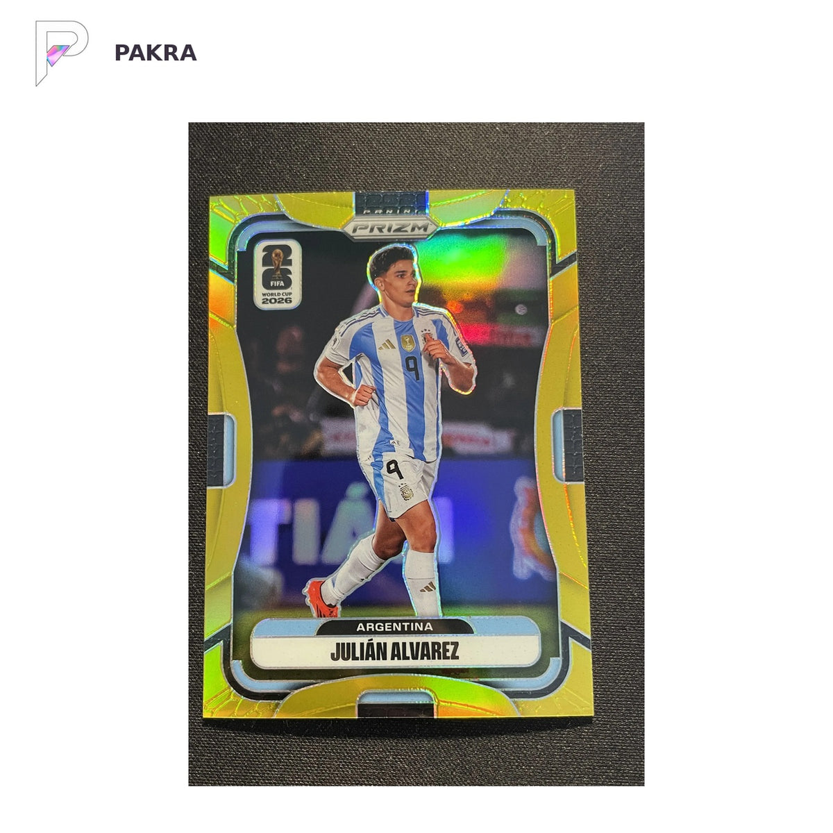 2026 Panini Prizm FIFA World Cup Julian Alvarez #1 Gold 9/10 JSY Number shown on a white PAKRA background.