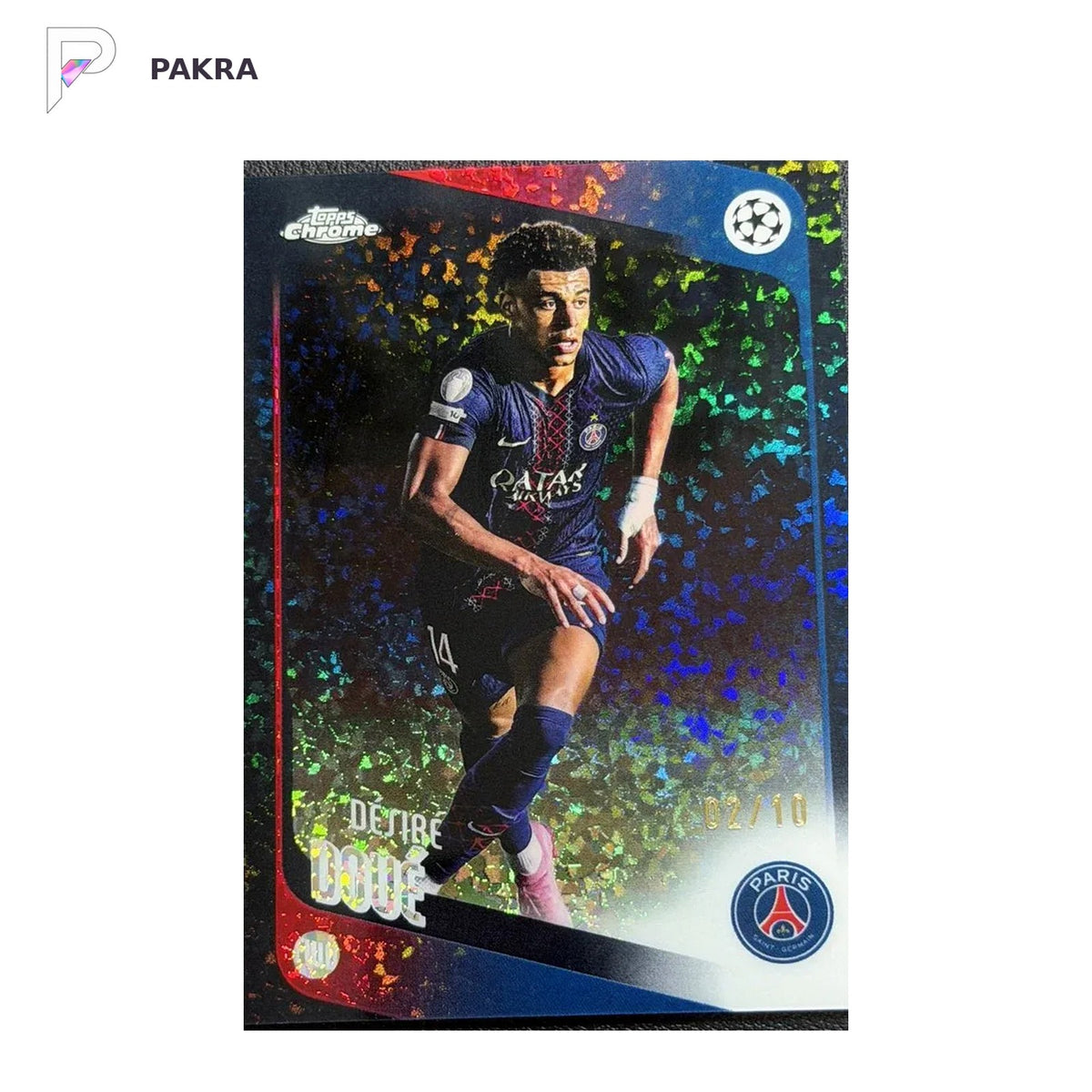 2025-26 Topps Chrome UEFA Desire Doue Black Speckle Refractor /10 shown on a white PAKRA background.